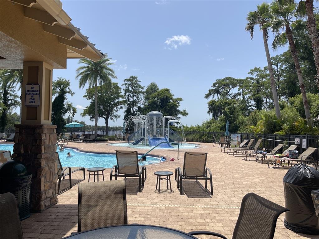 11901 Castine Street New Port Richey, FL 34654 - Photo 24 of 27 a view of a patio with couches and table and chairs and potted plants