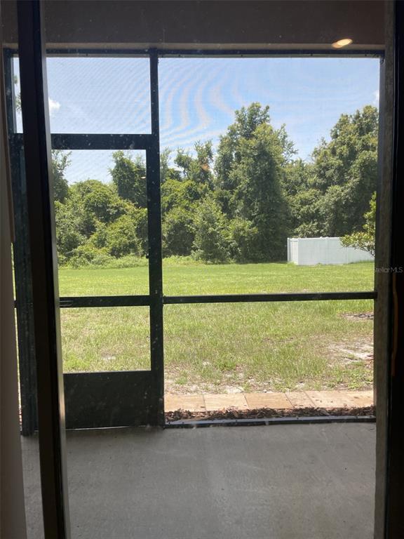 11901 Castine Street New Port Richey, FL 34654 - Photo 3 of 27 a view of a glass door with a yard from a window
