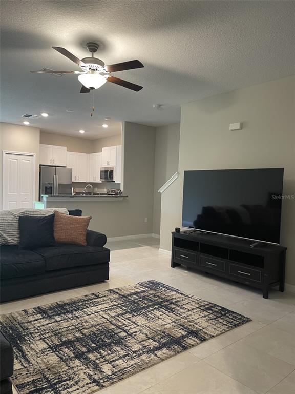 11901 Castine Street New Port Richey, FL 34654 - Photo 9 of 27 a living room with furniture and a flat screen tv