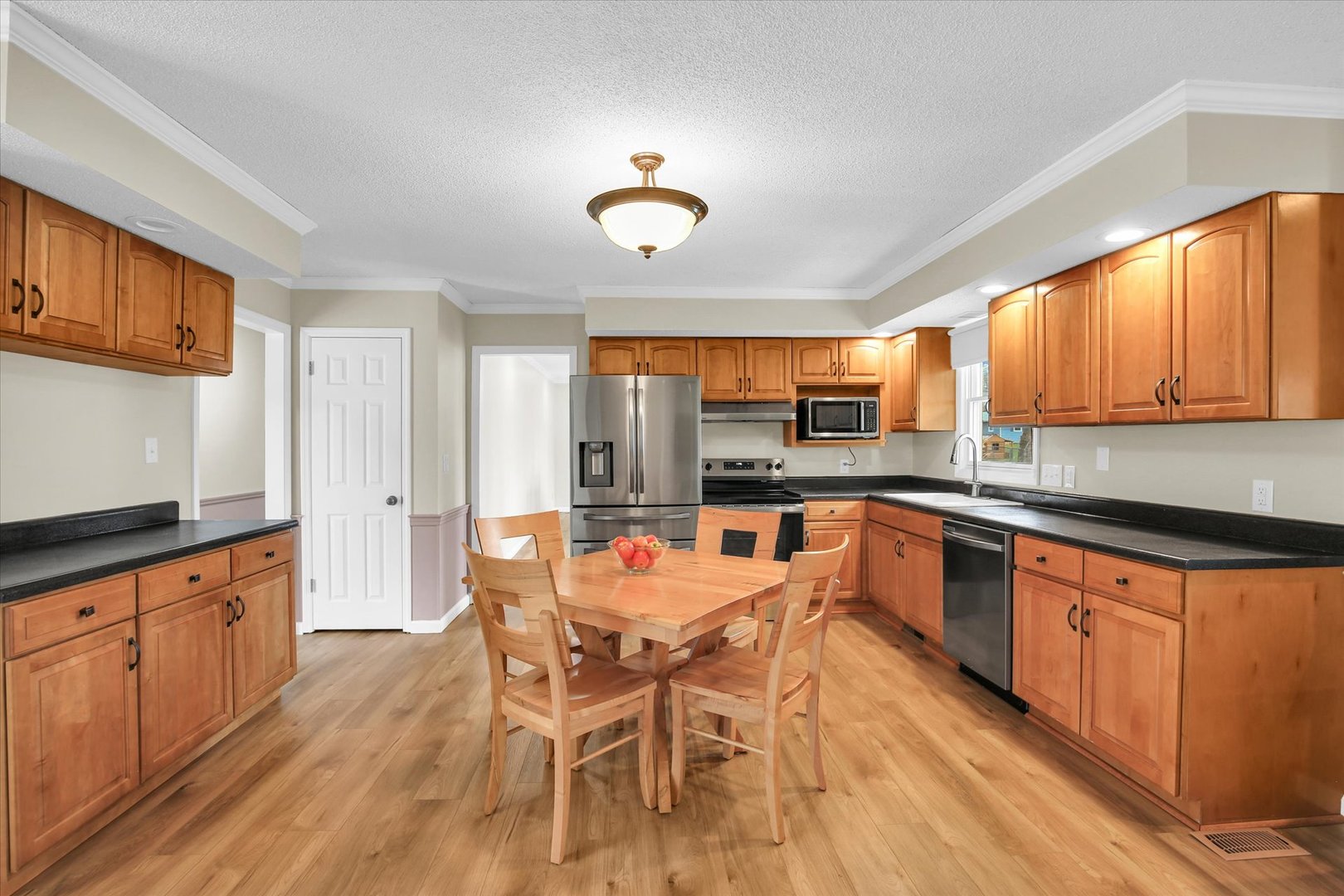 3629 Tuttle Street Danville, IL 61832 - Photo 7 of 47 a large kitchen with a table and chairs in it