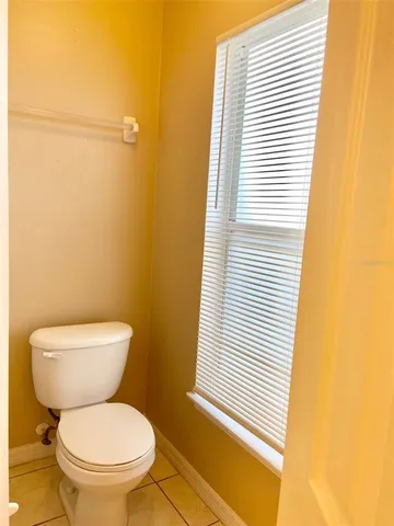a white toilet sitting next to a bathroom sink