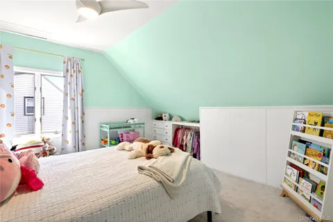a bedroom with a bed and a book shelf