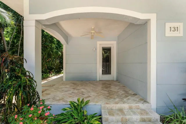 an empty room with potted plants and floor to ceiling window