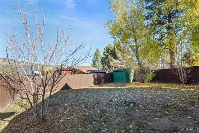 a view of backyard with large trees
