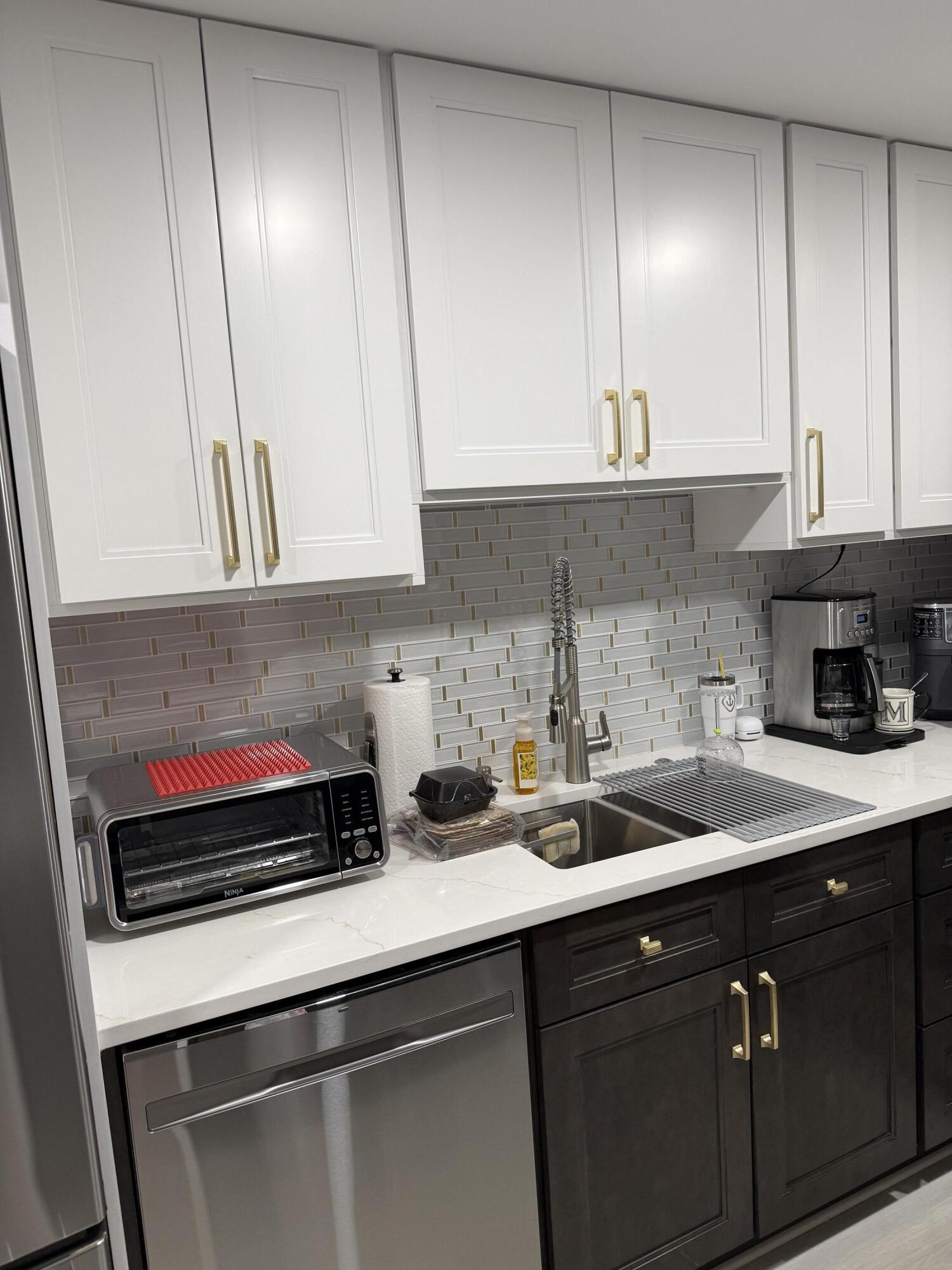 1066 Ainslie Drive, Unit 1066 Boca Raton, FL 33434 - Photo 1 of 28 a kitchen with a sink and cabinets