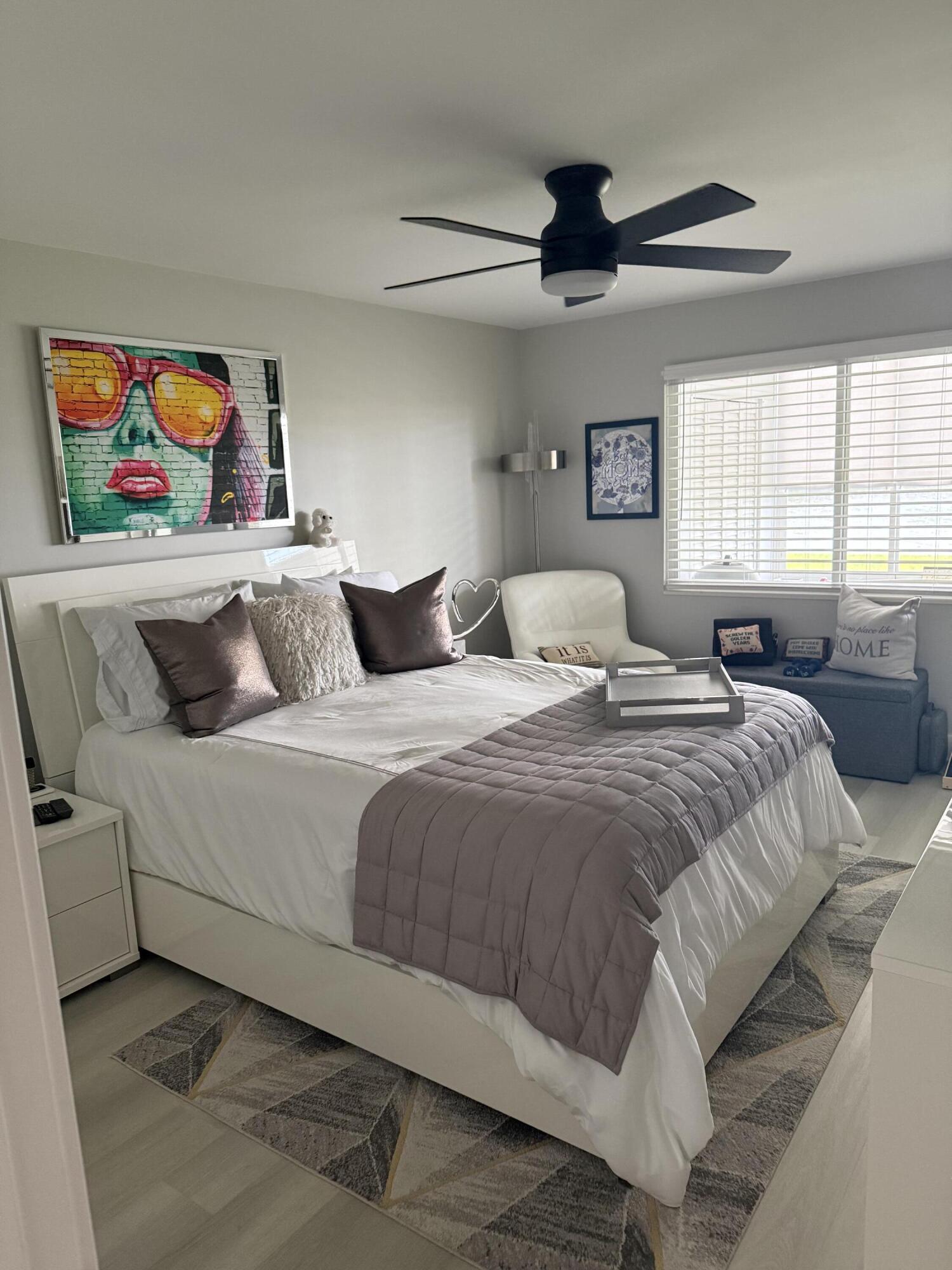 1066 Ainslie Drive, Unit 1066 Boca Raton, FL 33434 - Photo 13 of 28 a bedroom with a bed and painting on the wall