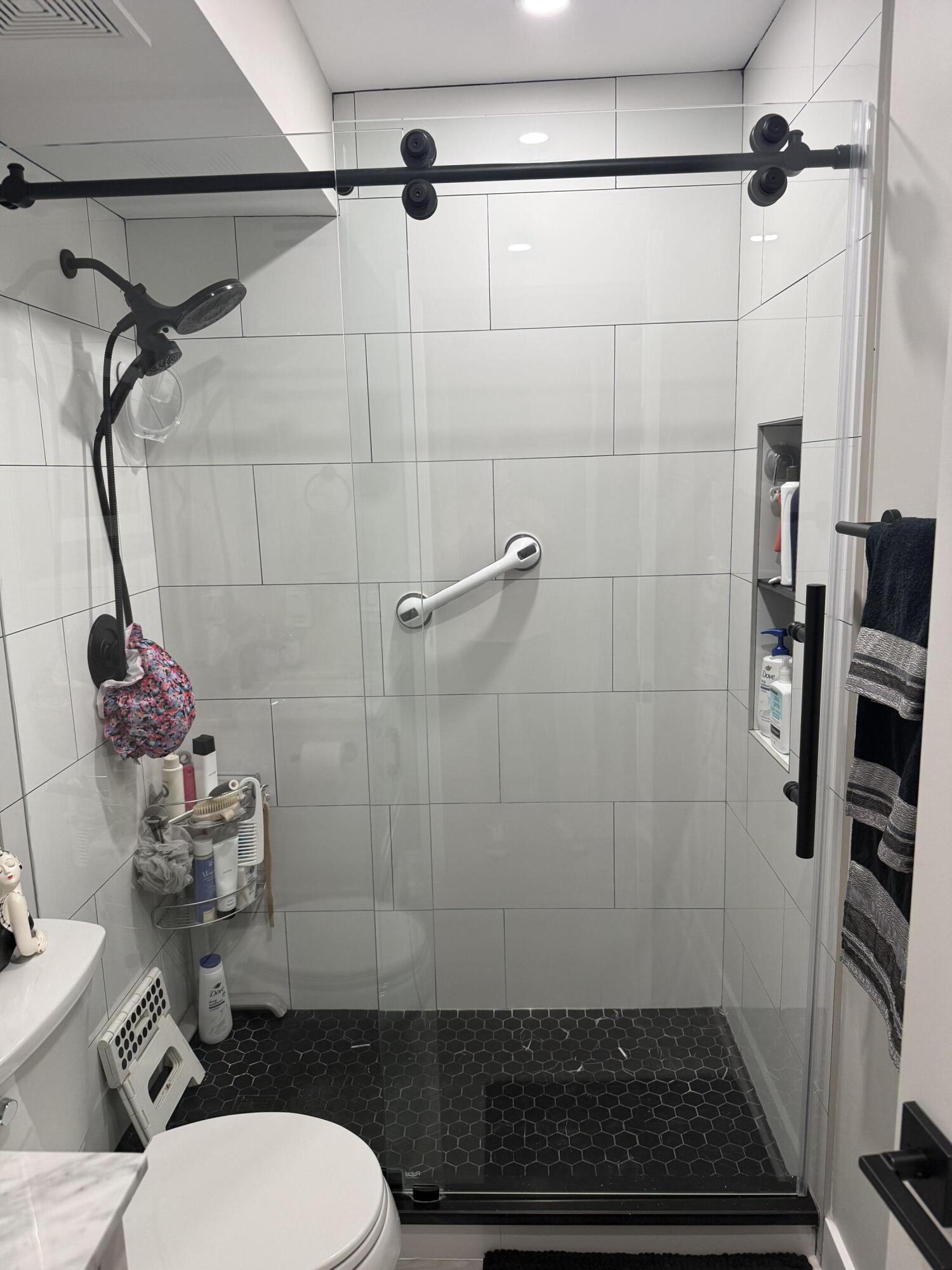 1066 Ainslie Drive, Unit 1066 Boca Raton, FL 33434 - Photo 14 of 28 a bathroom with a sink toilet and shower