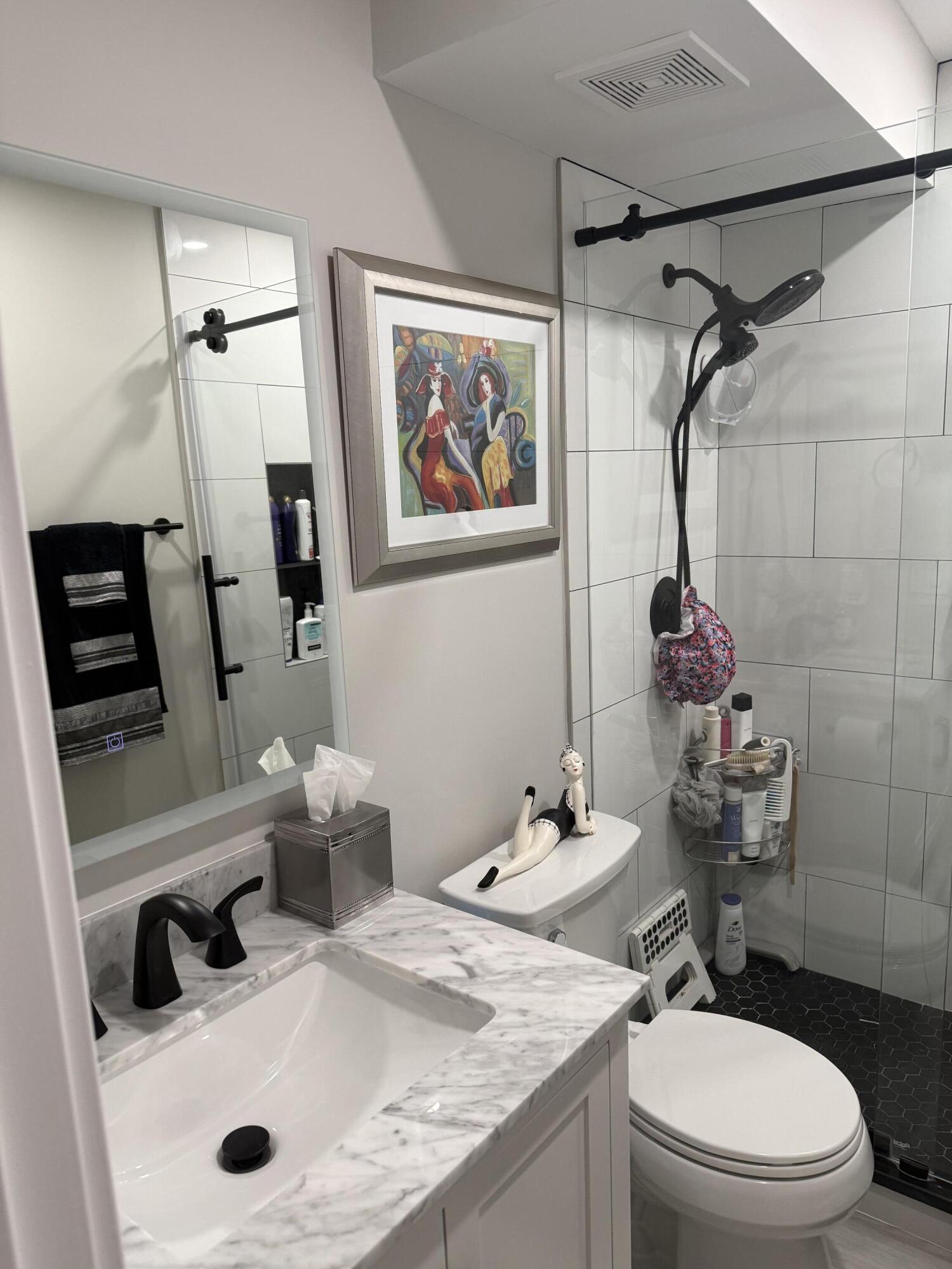 1066 Ainslie Drive, Unit 1066 Boca Raton, FL 33434 - Photo 15 of 28 a bathroom with a sink mirror vanity and toilet
