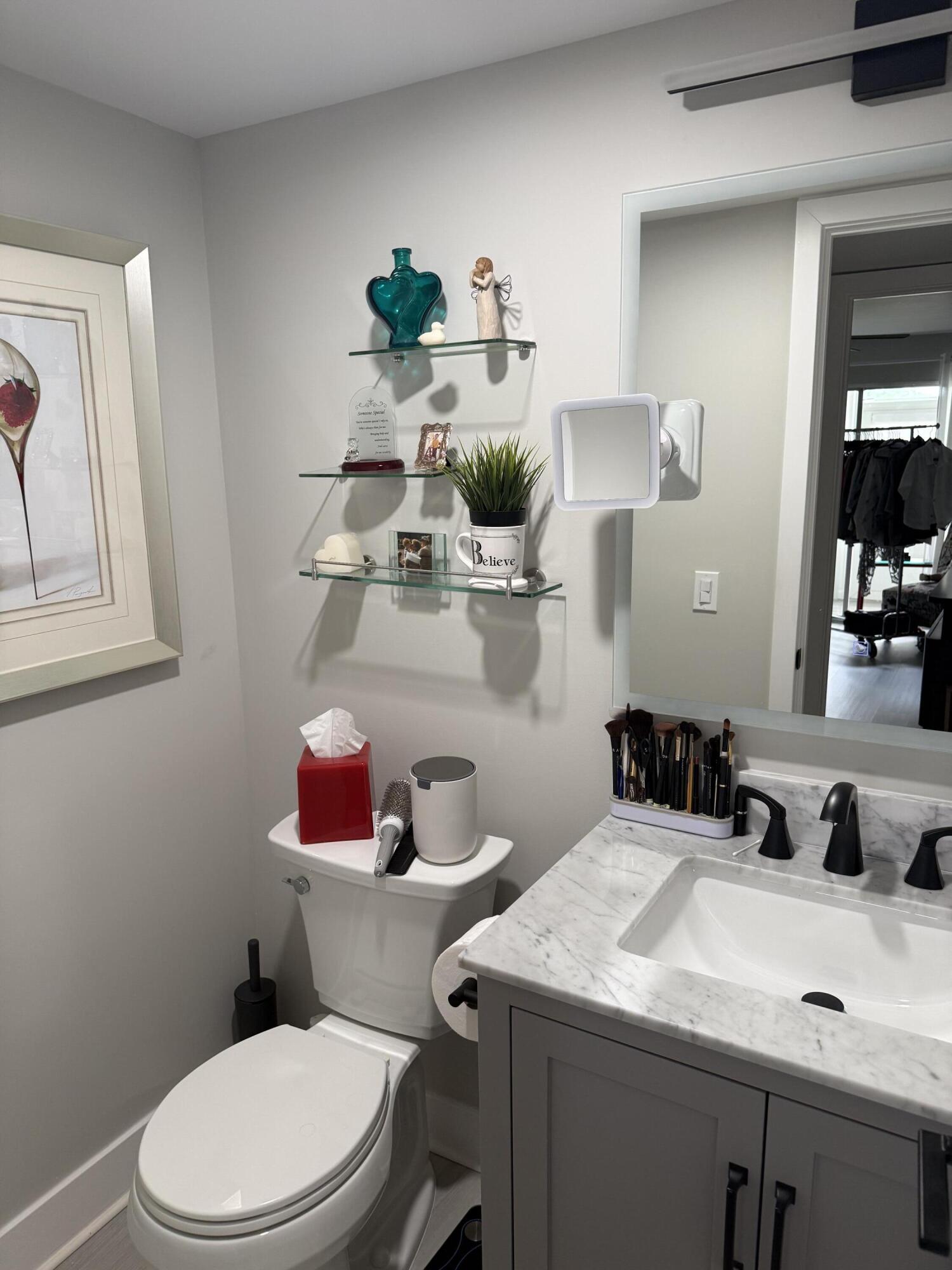 1066 Ainslie Drive, Unit 1066 Boca Raton, FL 33434 - Photo 16 of 28 a bathroom with a sink mirror and toilet
