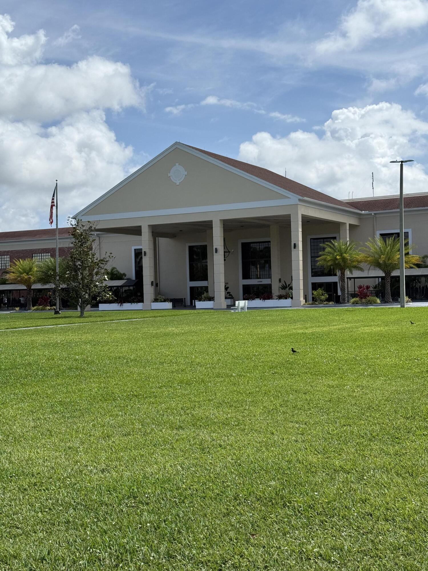 1066 Ainslie Drive, Unit 1066 Boca Raton, FL 33434 - Photo 23 of 28 a front view of a house with garden and trees