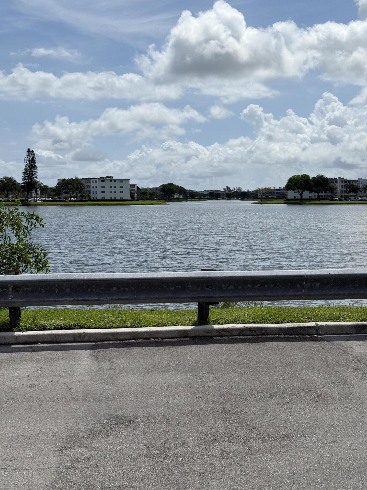 1066 Ainslie Drive, Unit 1066 Boca Raton, FL 33434 - Photo 26 of 28 a view of lake with green space