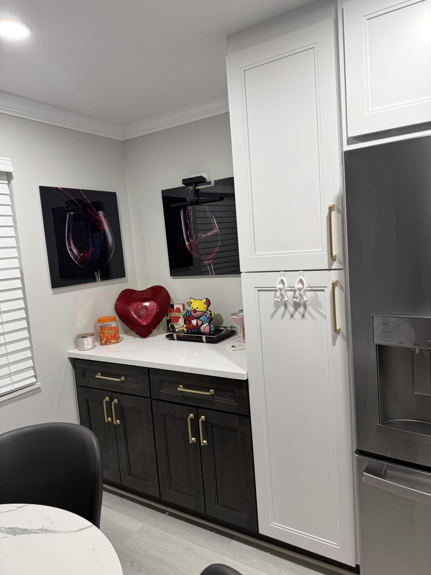 1066 Ainslie Drive, Unit 1066 Boca Raton, FL 33434 - Photo 3 of 28 a white refrigerator freezer sitting inside of a kitchen with stainless steel appliances wooden floor