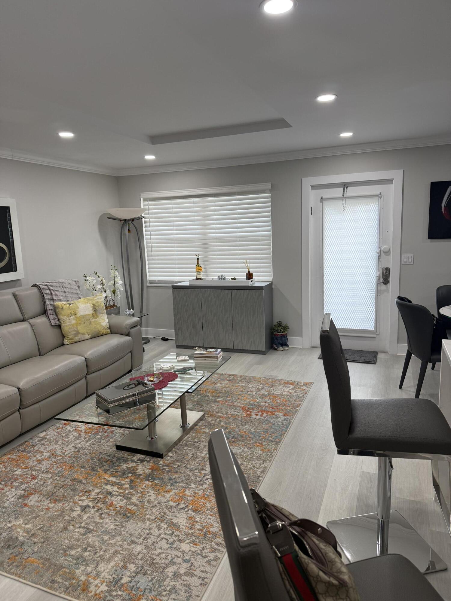 1066 Ainslie Drive, Unit 1066 Boca Raton, FL 33434 - Photo 9 of 28 a living room with furniture and wooden floor