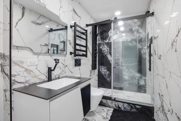 a bathroom with a sink toilet and shower