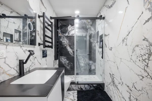 a bathroom with a bathtub and shower