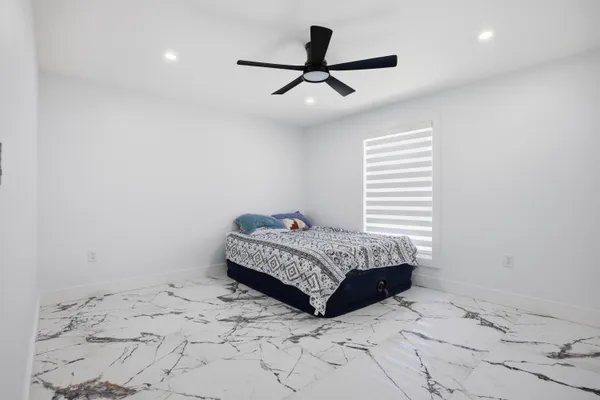 a living room with a bed and a window