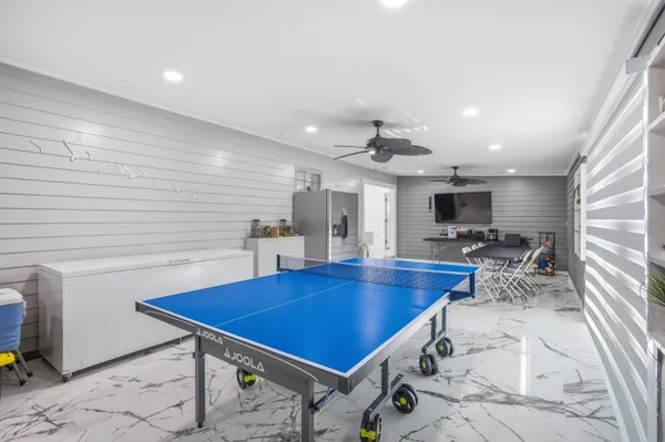 a room with furniture pool table and flat screen tv
