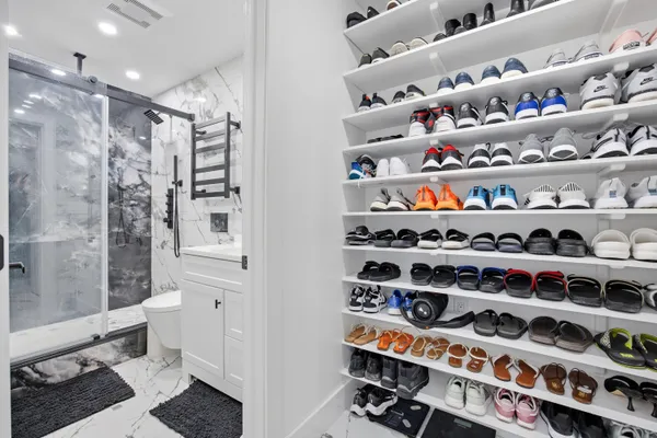 a kitchen with lots of clutter and stainless steel appliances