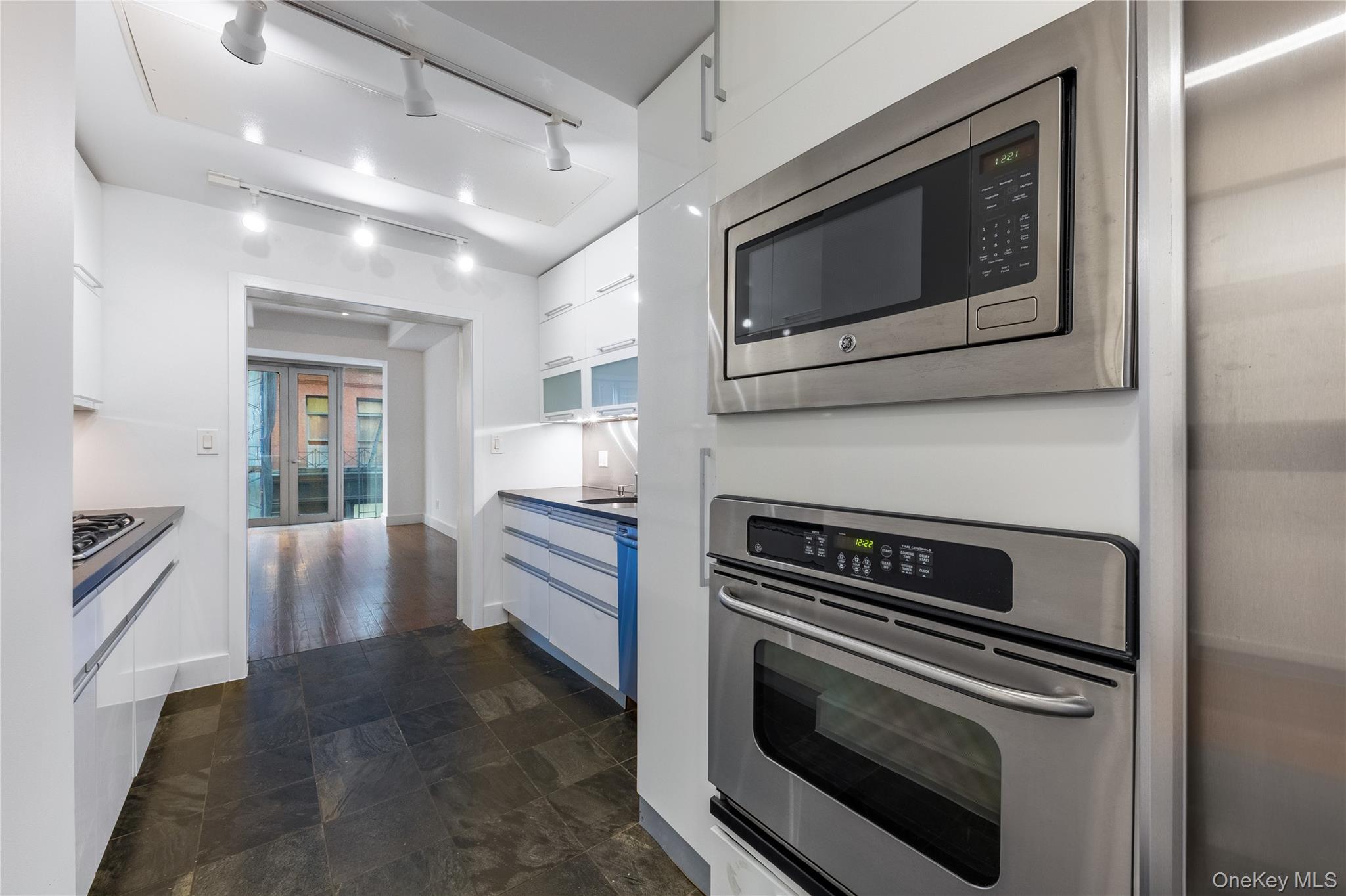 116 West 22nd Street, Unit 3 Manhattan, NY 10011 - Photo 17 of 27 a kitchen with a stove and a microwave