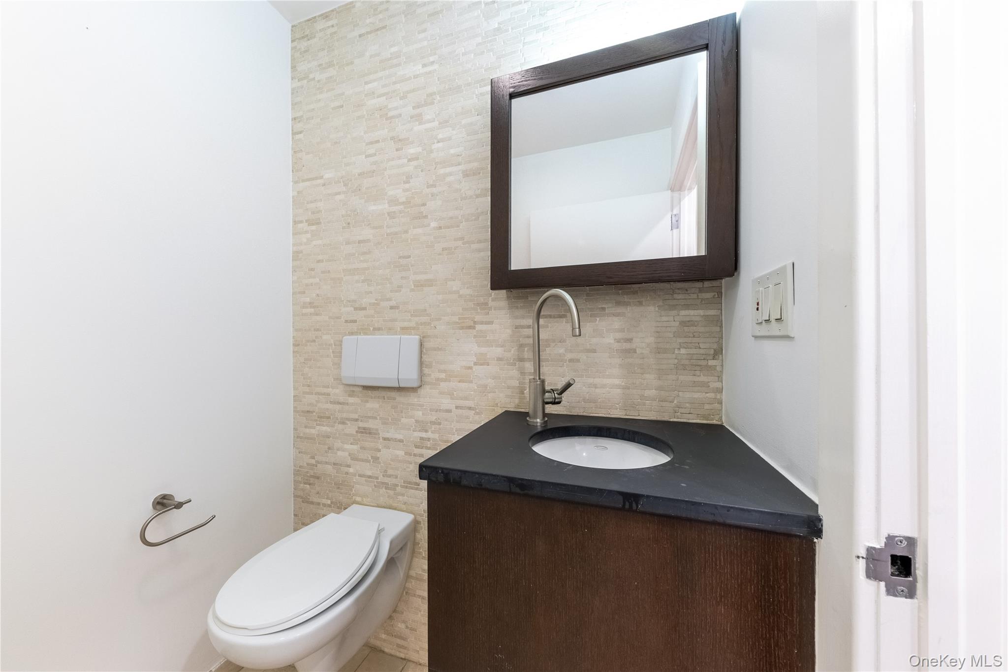 116 West 22nd Street, Unit 3 Manhattan, NY 10011 - Photo 18 of 27 a bathroom with a toilet sink and mirror