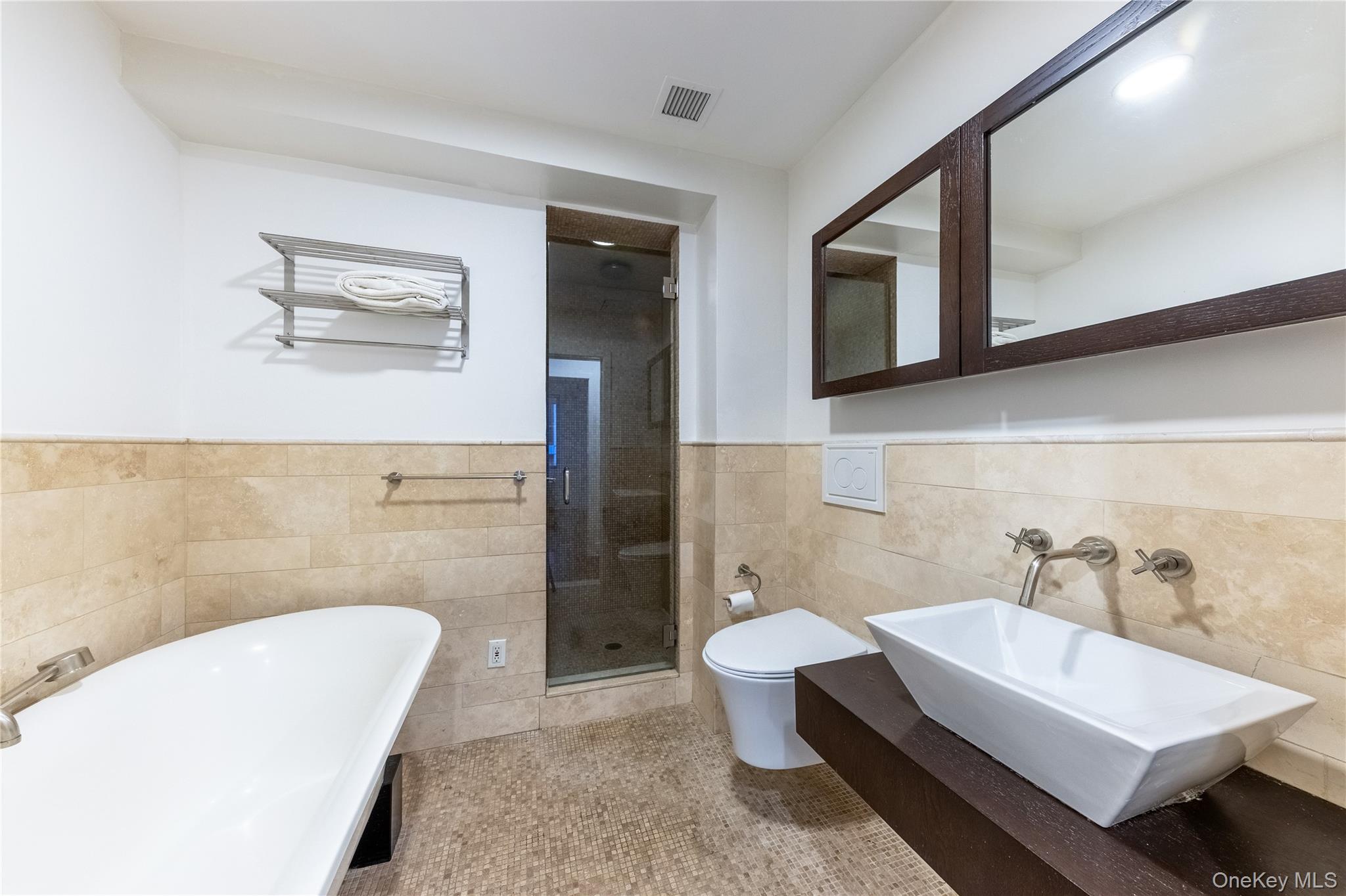116 West 22nd Street, Unit 3 Manhattan, NY 10011 - Photo 21 of 27 a bathroom with a sink a toilet and mirror
