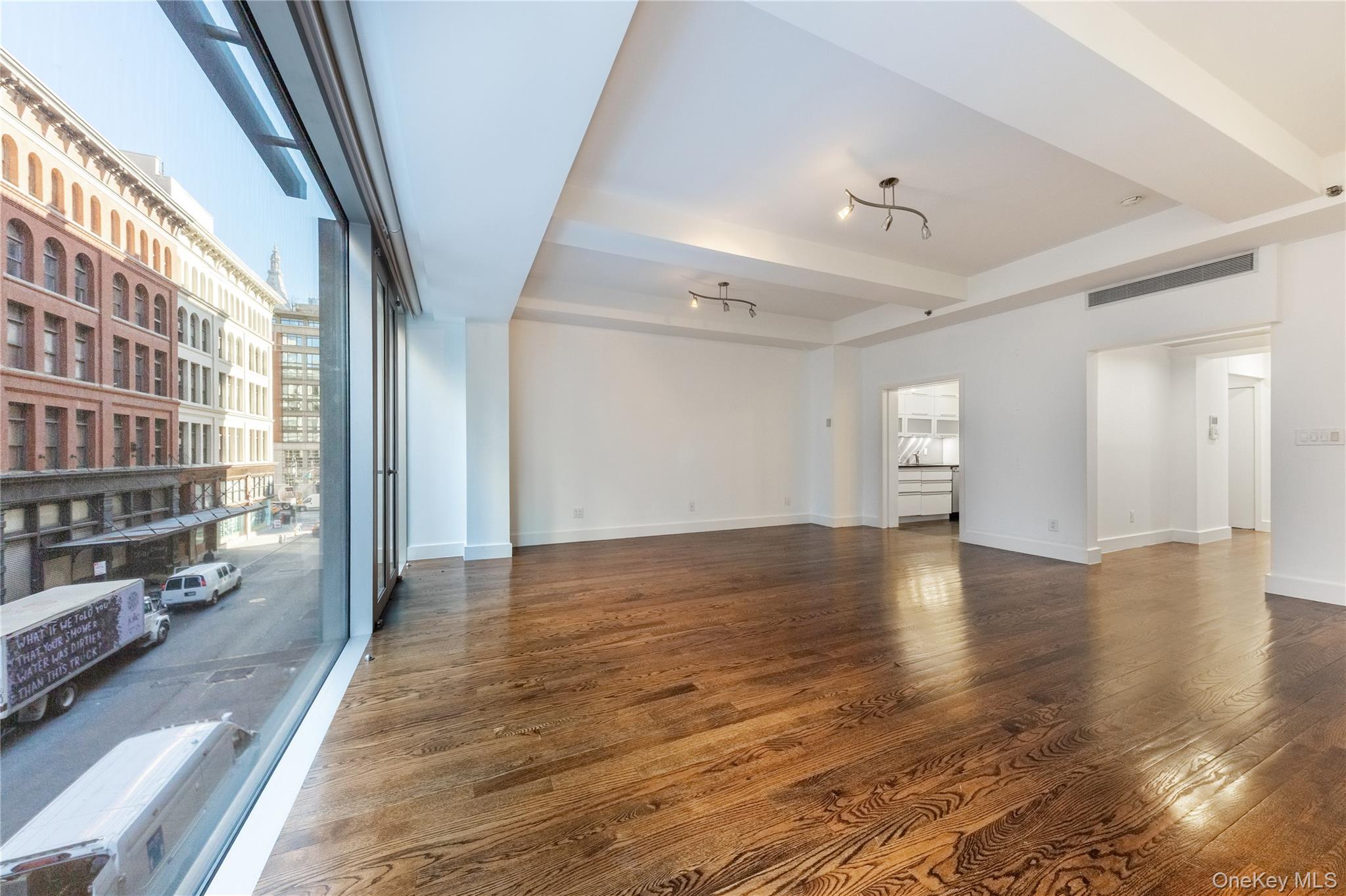 116 West 22nd Street, Unit 3 Manhattan, NY 10011 - Photo 26 of 27 a view of a big room with wooden floor and windows