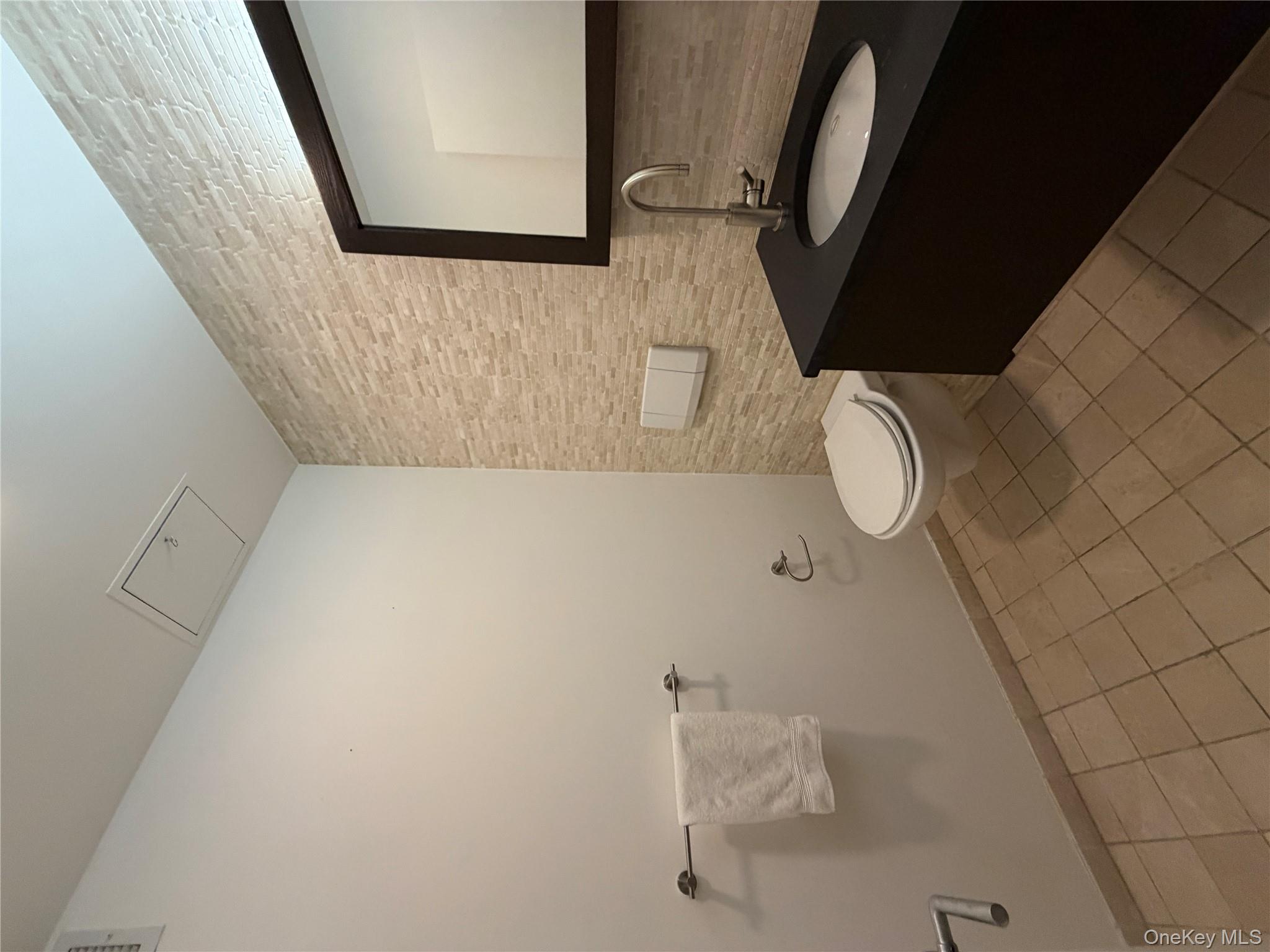 116 West 22nd Street, Unit 3 Manhattan, NY 10011 - Photo 5 of 11 Half bathroom featuring vanity and light tile patterned floors