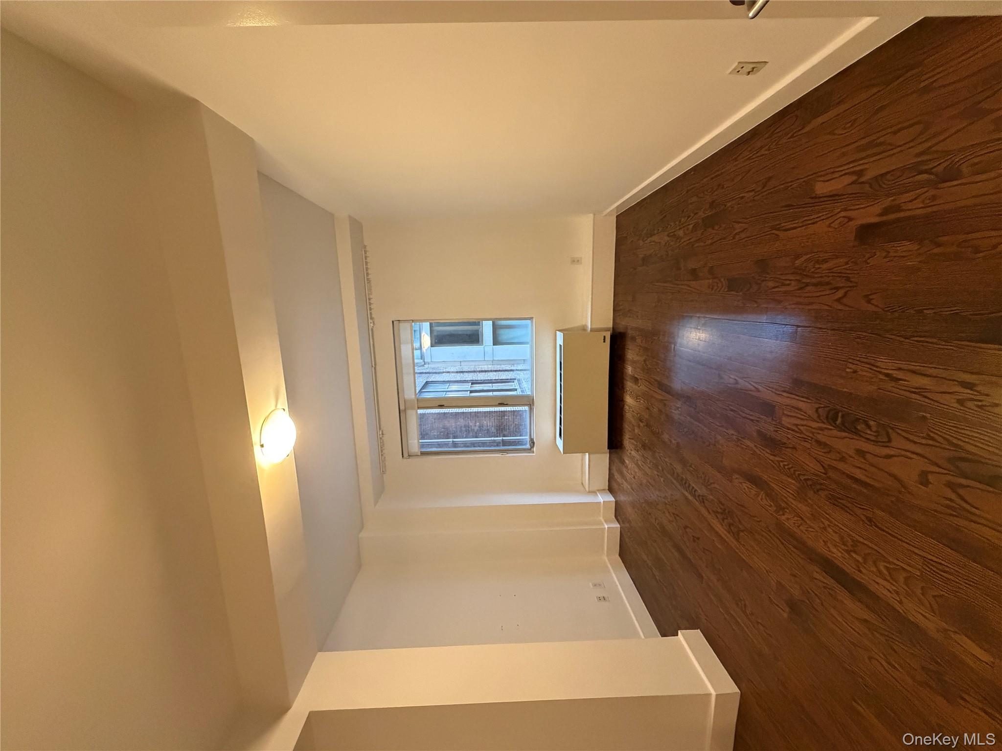 116 West 22nd Street, Unit 3 Manhattan, NY 10011 - Photo 6 of 11 Spare room featuring radiator heating unit and dark wood-style floors