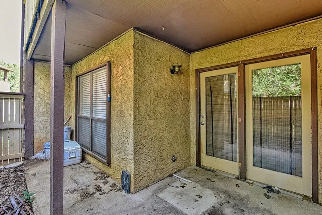a view of a hallway with a glass door and balcony