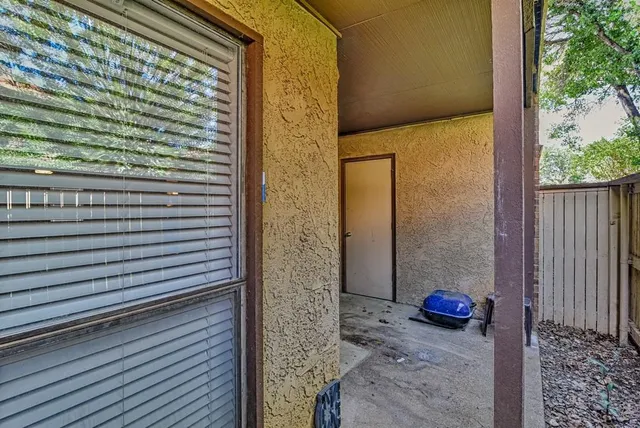 a view of a door and chair in the patio