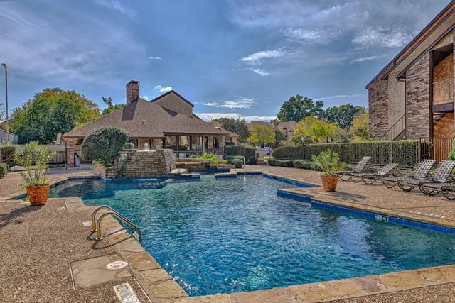 a view of a house with garden and a sitting area
