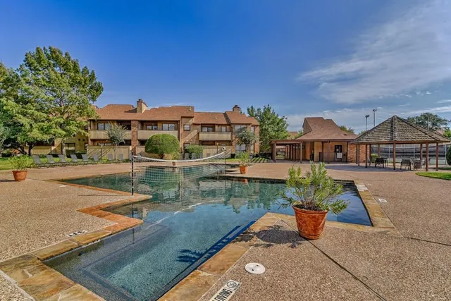 a view of a house with pool and lake view