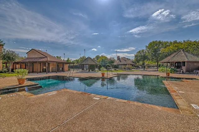 a view of a house with swimming pool and sitting area