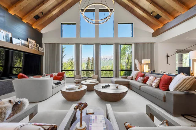 a living room with furniture a fireplace and a large window