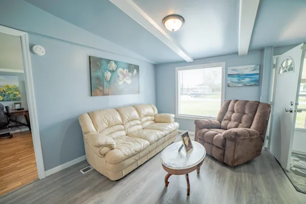 a living room with furniture and a large window