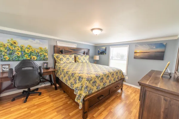 a bedroom with a bed and a chandelier