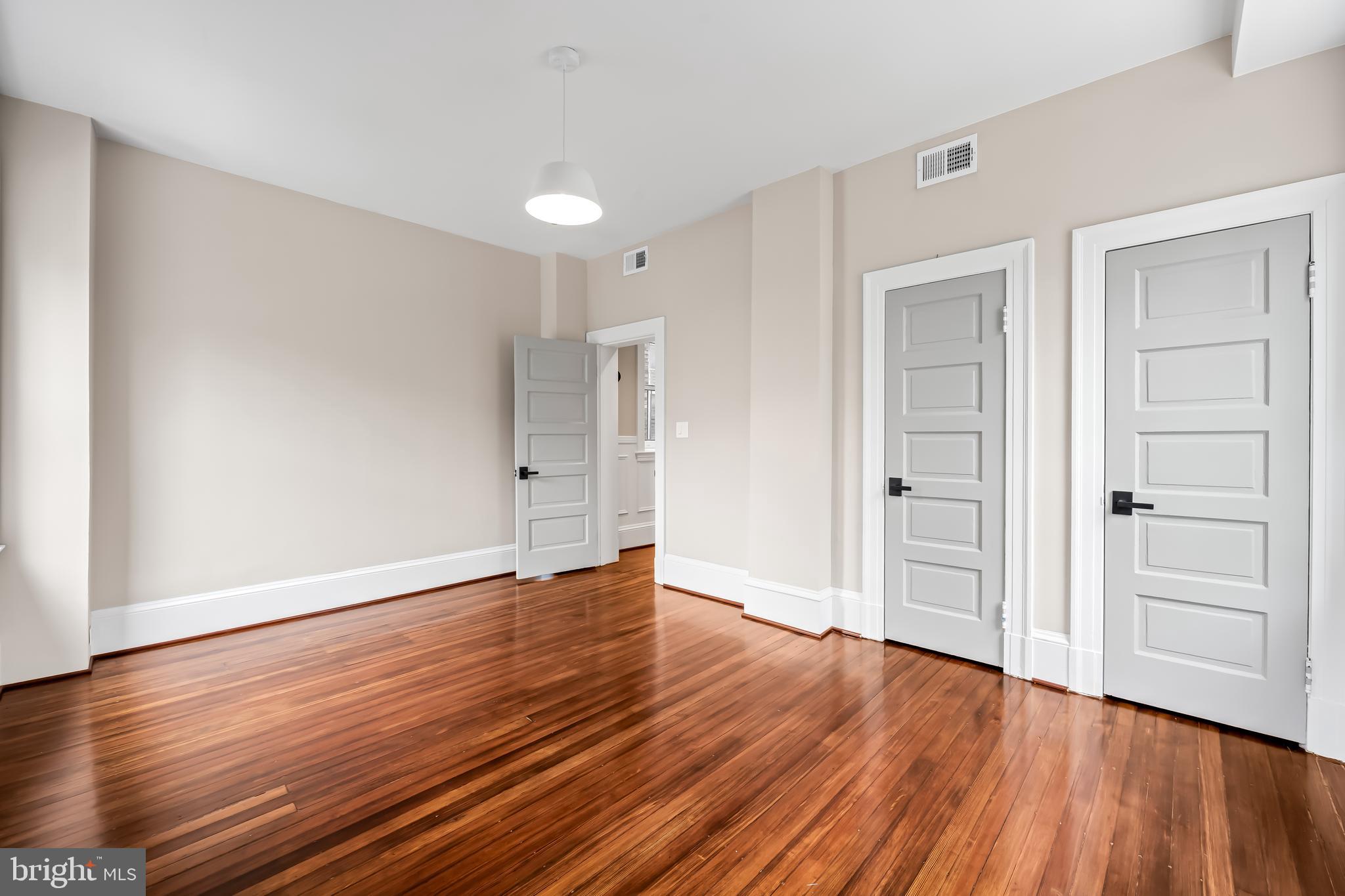 1202 Bolton Street, Unit 2 Baltimore, MD 21217 - Photo 17 of 25 a view of an empty room with wooden floor