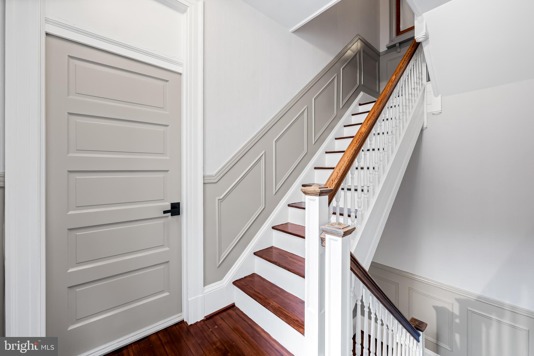 1202 Bolton Street, Unit 2 Baltimore, MD 21217 - Photo 5 of 25 a view of staircase with wooden floor and white walls