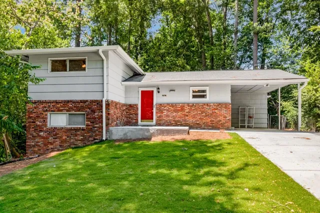 a front view of house with yard and green space