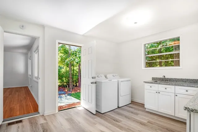 a view of a kitchen with wooden floor and electronic appliances