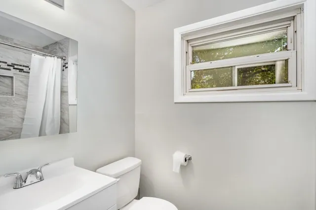 a white toilet sitting next to a bathroom sink