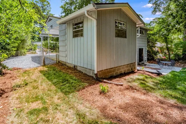 a view of a small house with backyard