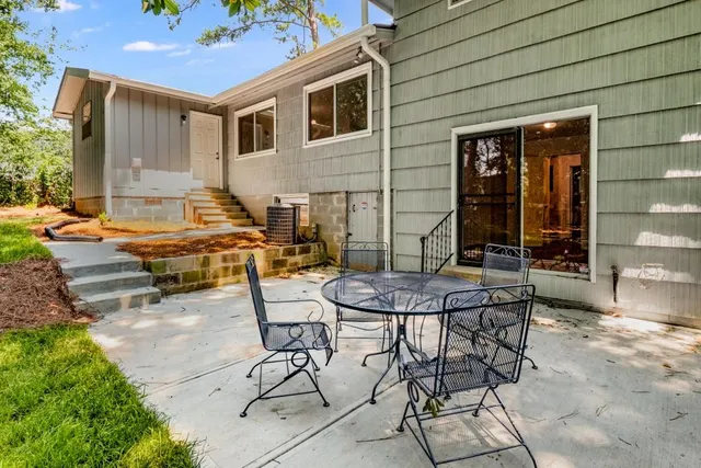 a backyard of a house with outdoor seating