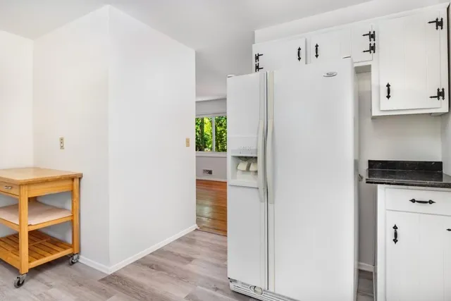 a kitchen with stainless steel appliances a refrigerator a stove a microwave and cabinets