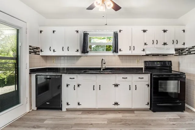 a kitchen with stainless steel appliances granite countertop a stove a sink and a refrigerator