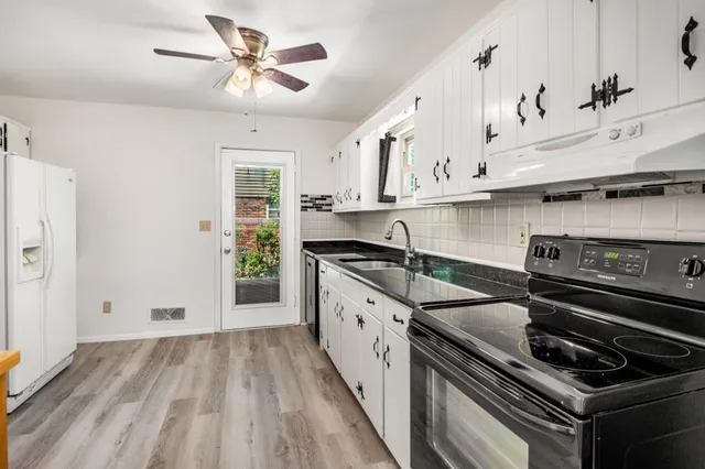 a kitchen with stainless steel appliances granite countertop a stove and a sink