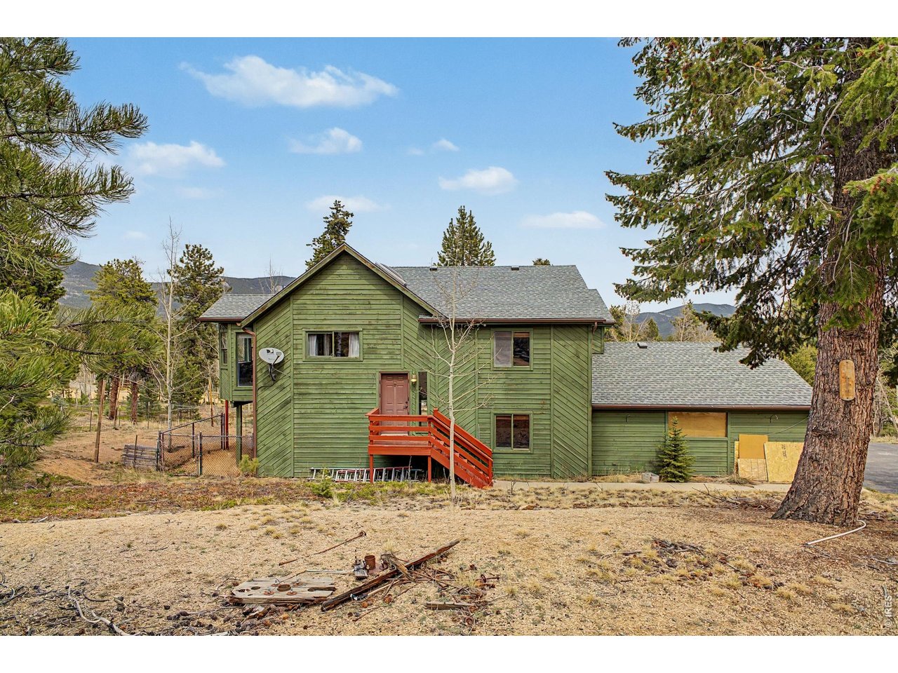 76 Highlands Drive Bailey, CO 80421 - Photo 5 of 49 a front view of a house with a yard and garage