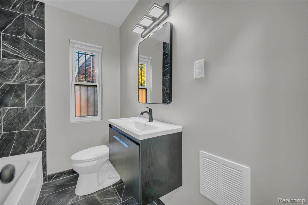 16717 Fielding Street Detroit, MI 48219 - Photo 29 of 46 Bathroom featuring vanity and dark marble finish flooring
