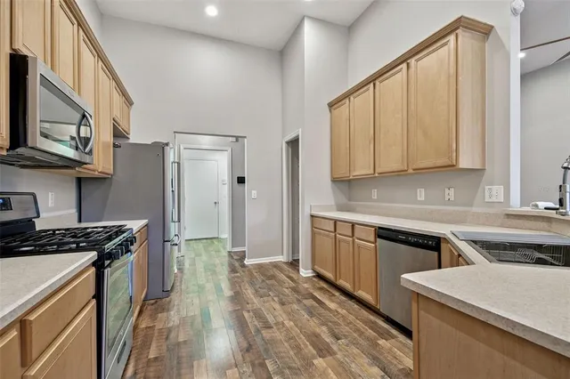 a kitchen with a sink stove and refrigerator
