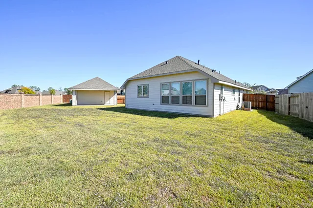 a front view of a house with a garden and yard
